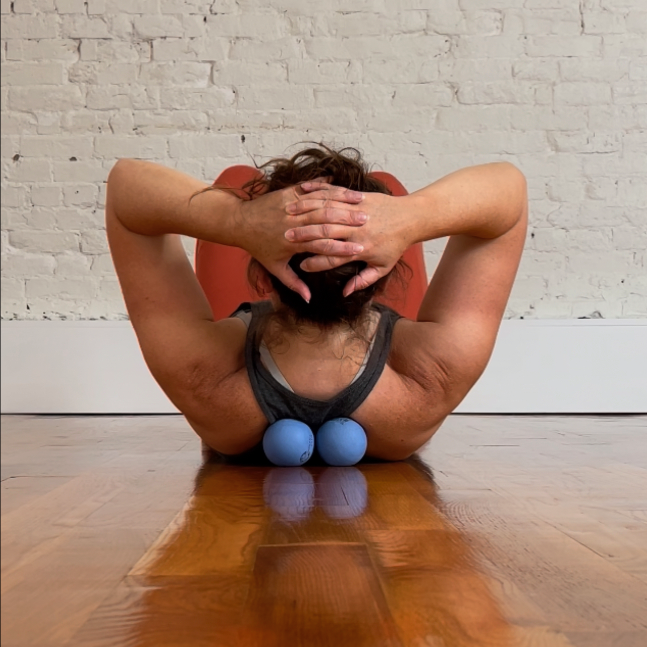 Kate Hamm rolling mid-back using the Roll Model Method therapy balls for self-massage.